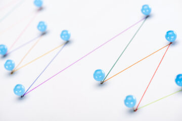 close up view of colorful connected drawn lines with pins, connection concept